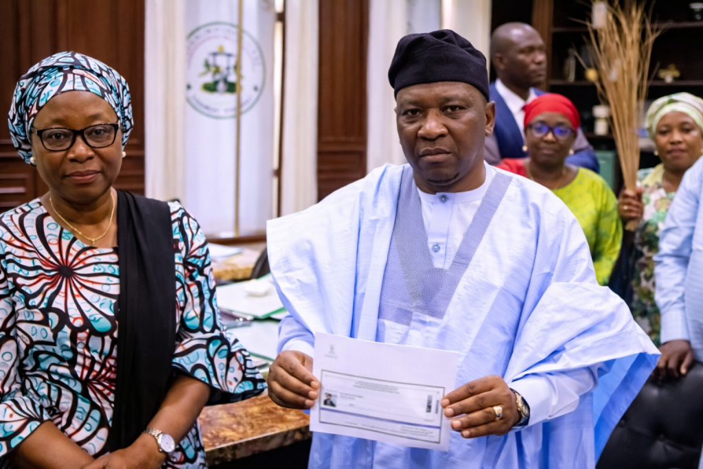 Gov Fintiri Along his wife Showing his APC card