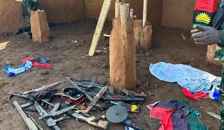 Interior of a rustic building with weapons.