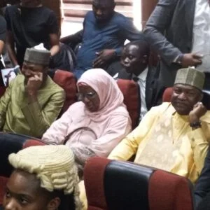 People seated in a formal setting.