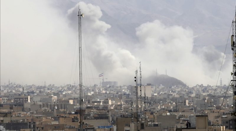 Smoke rising over a cityscape.